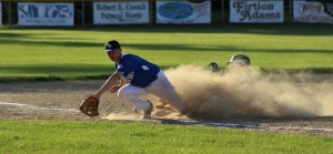The action at Friday night's Babe Ruth Baseball Dan Welch City Cup championship was often hotly contested, and, like this play, left the players searching for daylight in a cloud of dust. (Photo by Kellie Adam)