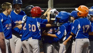 Teammates swarm Westfield American’s Jeremy McCormick after McCormick blasted a two-run home run Thursday night in Belchertown. (Photo by Chris Putz)