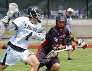 Westfield’s Matthew Bonsal, right, defends the Longmeadow ball carrier during a West/Central Division 2 boys' lacrosse quarterfinal Saturday. (Photo by Chris Putz)