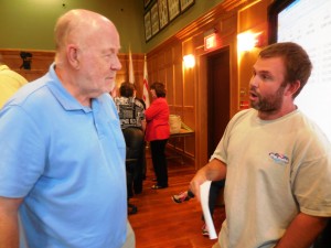 School Committee member William Duval and resident and property owner Matthew Emmershy continue the debate following the public hearing on the Westfield city budget Monday. (Photo by Amy Porter)