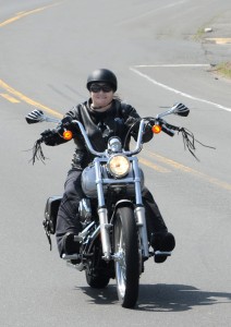 Lori McElhiney of Westfield, the Massachusetts coordinator for Stilettos on Steel, rides her Harley with other members of the women’s motorcycle riding group during a recent run through Westfield. (Photo © 2016 Carl E. Hartdegen)  