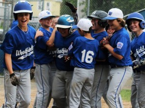 Scott Hepburn gets congratulated by his teammates after hitting a home run. (Photo by Kellie Adam)