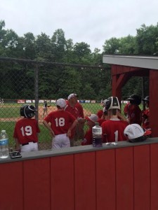 Westfield National's players are getting advice from their coaching staff in between innings.