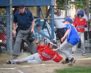 A close play at the plate unfolds between the Westfield American and Westfield National Little League Baseball 11-12-Year-Old All-Stars Monday night at Ralph E. Sanville Field on Cross Street. (Photo by Marc St. Onge)