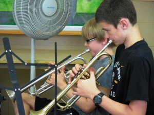 Seventh-graders Charles Darling and Alex Fontanilles work on a trumpet part at practice. (Photo by Amy Porter)