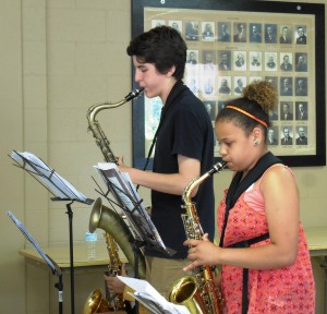 Eighth-grader Steven Bonacci and freshman Deajah Barbour play a saxophone duet during practice. (Photo by Amy Porter)