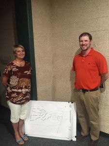 Partial business owners of the proposed disc golf course, Freda Brown and Drew Gardner, stand by the revised plan created by Randy Brown. (Photo by Greg Fitzpatrick)