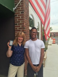 Sue Bartlett holds up her IPhone that Tyshaun Davis was able to find in Springfield. (Photo by Greg Fitzpatrick)