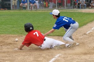 Westfield National's Anthony Schabowski slides into third base as Westfield American's Liam Poole looks to apply the tag. (Photo by Marc St. Onge)