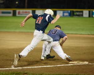 Missing something? Sarasota's Zac Calhoon runs out of a shoe trying to make first base while Pittsfield's Jacob Harrington goes for the stop Sunday night at Bullens Field. (Photo by Marc St. Onge)