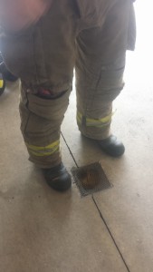 Small tear at the knee of one of the firefighter's turnout gear. 