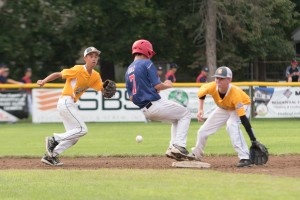 Bismarck and West Linn converged on an infield play in Thursday's first day of Babe Ruth Baseball 14-Year-Old World Series play. (Photo by Marc St. Onge)