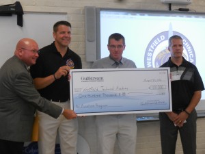 Fran Ahern, General Manager of Gulfstream Westfield (r) presents a check for $100,000 to (from l-r) Westfield Technical Academy principal Joe Langone, WTA Aircraft Maintenance Technology instructor Galen Wilson and Westfield Schools Superintendent Stefan Czaporowski (photo by Amy Porter)