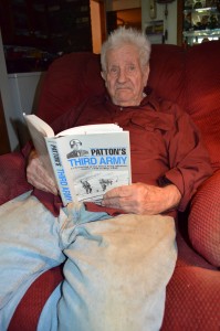Jay Yaple of Westfield has vivid memories of the day he was captured by the Germans in World War II. He is seen in his home with one of his favorite books.