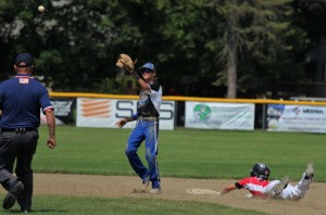 Moutain Home (AR) shortstop Josh Prinner looking to stop Janesville ‘s (WI) Cody Logterman from stealing second base. (Photo by Kellie Adam)