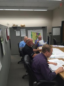 Members of the Lake Management Committee are looking over the minutes from past meetings before they officially start their meeting. (Photo by Greg Fitzpatrick)
