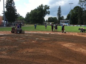 Volunteers prep the field for play.