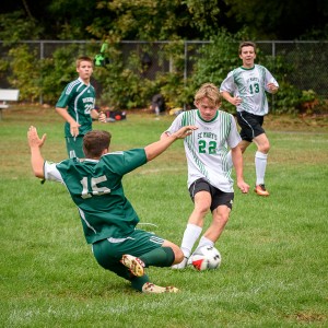 St. Mary's Matt Masciadrelli tries to make it past a sliding Ware defender Monday at Westfield Middle School North. (Photo by Marc St. Onge)
