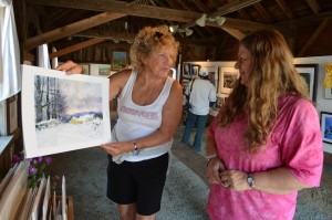 Joan Boryta was one of the artists who presented weekend workshops at the Blandford Fair. Boryta, holding one of her watercolors, is seen with Christine Tighe, art show supervisor.