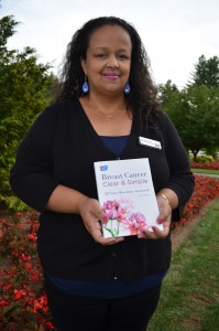 Crystal Brown, MS, senior market manager, community engagement, for the New England Division of the American Cancer Society, displays the new breast cancer book available to the public.