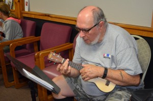 Wayne Weatherwax intently looks at the sheet music before trying a chord.