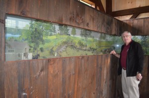 Bob McKean flanks a diorama of Stanley Park which has been an integral part of the Carriage House for years.