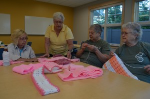 Agnes Fleming, second from left, checks out some of the recent pink scarves made by the Sassy Stitchers Knit & Crochet group at the Westfield Senior Center. Fleming is an activities aide at the center. Seen with Fleming are Rose White, Lana Fitzgerald and Persis Webb.