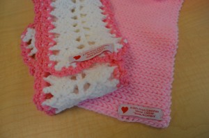 Scarves made by the Sassy Stitchers Knit & Crochet group at the Westfield Senior Center have a label stitched in. Scarves are given to breast cancer survivors at the Rays of Hope Run and Walk.