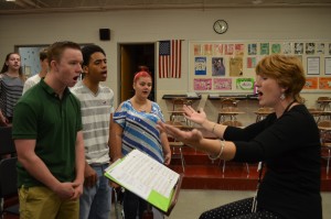 Korey Bruno, director of choral activities at Westfield High School, works with students Friday morning on a song from the "Phantom of the Opera." From left, senior Connor McDowell, junior Martin Benitez, and sophomore Rebekah Boudreau.