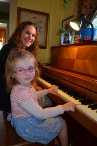 Abigail Vassallo enjoys her time at the Baldwin piano with her mother, Alexandria Vassallo.