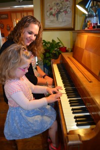 Abigail Vassallo, seen with her mother, Alexandria Vassallo, rehearse a song on their Baldwin piano, Vassallo is coordinating the first Western Mass. Jingle Bell Run for the Arthritis Foundation to draw attention to children with arthritis.