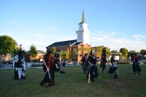 Members of the Whip City Witches rehearse for an upcoming performance on the Westfield Green.