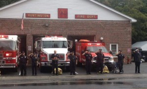 Members of the Huntington Fire Department stand in attention as the last of four sirens are sounded to remember the fallen of 9/11. (Left to right) FF Josh Mollison, Jr FF Desiree Lucia, Captain John McVeigh, FF Jeanine Lucia, Lt. Steve Graydon, FF Richard Wylie, FF Dylan Mosher, Asst Chief Josh Ellinger. (Submitted photo)