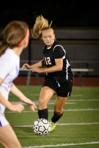 Westfield's Lindsey Kiltonic is determined to get past the West Side defender Tuesday night at Clark Field. (Photo by Marc St. Onge)
