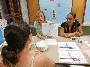 Michele Douglas and Felicita Cintron of SEPAC share information with a parent at the kickoff meeting in September. (Photo by Amy Porter)