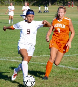 Westfield’s Gianna Katsounakis (9) dribbles around Agawam’s Jess Bonfiglio (2) in a high school girls’ soccer game Tuesday. (Photo by Chris Putz)