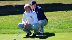 Bailey Loughlin and coach Jim Blascack read a putt. (Photo courtesy of Westfield State University Sports)