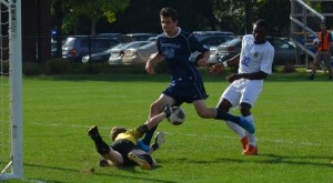 Western New England goalkeeper Kevin Strobel dives to thwart Alex Dragon's scoring chance in the first half. (Courtesy of Westfield State Sports)