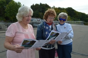 Jean Bush, Janice Brown and Fay Piergiovanni, all members of the Chester Historical Society, look at the program on Saturday morning at the Littleville Dam.