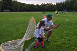 Charlie Anne White receives some tips from Westfield Parks and Rec coach Jeff Sarat on being a goalie prior to the start of a Pee Wee soccer game.