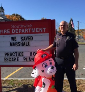 Southwick Police Lt. Kevin Bishop, stands with Marshall, who is now home safe at the fire department. (Photo by Greg Fitzpatrick)