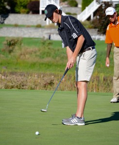 Westfield’s Ryan Towle makes a putt as an Agawam golfer, right, looks on Wednesday at The Ranch in Southwick. (Photo by Chris Putz)
