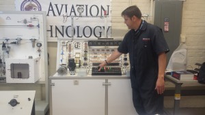 An instructor shows how one of the aviation simulation machines works.