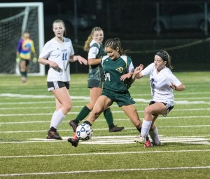 Southwick's Autumn Waitt (34) attempts to break through a pack of Granby players in a Division 2 girls' soccer west sectional Wednesday night at South Hadley High School. (Photo by Bill Deren)