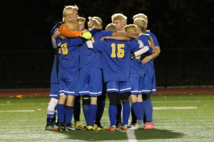 Gateway players, donning freshly died blonde hair, embrace for a pregame huddle prior to taking on Monson in a tournament semifinal Thursday night at East Longmeadow High School. (Photo by Kellie Adam)