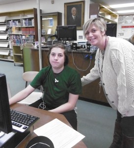 WHS guidance dept. chair Megan Stope assists Joel Collins with an online college application. (Photo by Amy Porter)