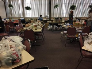 Food on top of desks that were donated to the radio food drive Monday. (Photo credit: Greg Fitzpatrick)