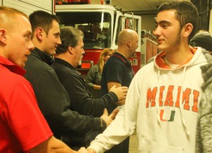 Westfield High’s Mark Rowe, right, thanks local firefighter Eric Liptak. (Photo by Kellie Adam)