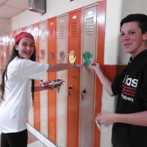 Jaclyn Towle, 2020 class president and John Peloquin, 2018 class representative taped turkeys with messages on all the student lockers Monday. (Photo by Amy Porter)