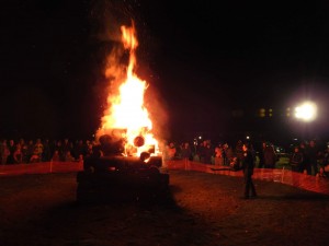 John McVeigh uses blower on the bonfire as residents warm themselves. (Submitted photo by Tim Doherty)